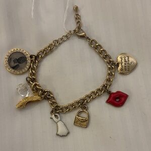CHARM BRACELET….MARILYN MONROE THEMED GOLD TONE BRACELET SEVEN DIFFERENT CHARMS